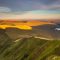 A sunlight view of the Cribyn mountain peaks and Upper Neuadd reservoir from Pen Y Fan, in the Bannau Brycheiniog National Park, Wales.